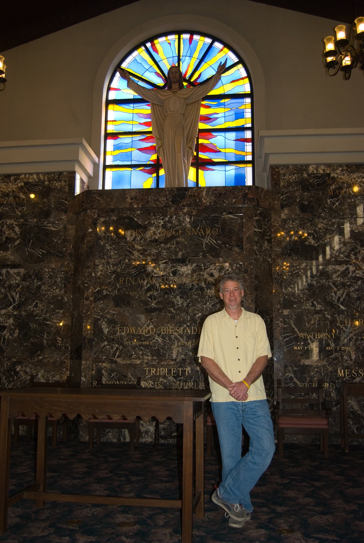 Keith S. Bramer beneath an installed memorial window