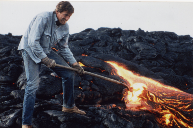 Keith S. Bramer gathering molten glass from an active lava flow